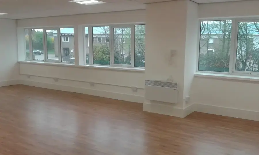 Empty office space to let in Manchester with large windows and wood flooring